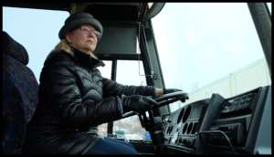 Lisa in the drivers seat of Maggie the art bus