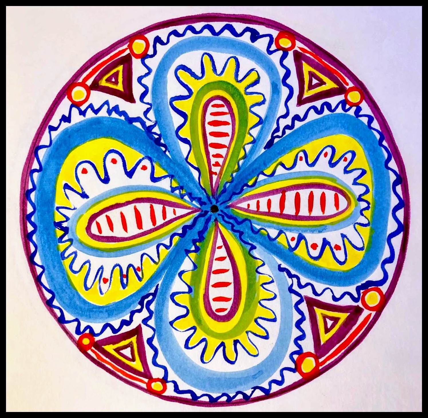 Colorful patterned mandala drawn with marker on paper