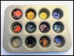 Muffin tin with sorted mosaic collage pieces